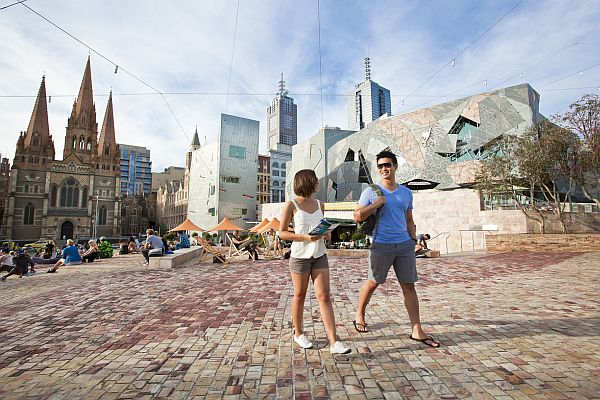 Couple walking through Federation Square